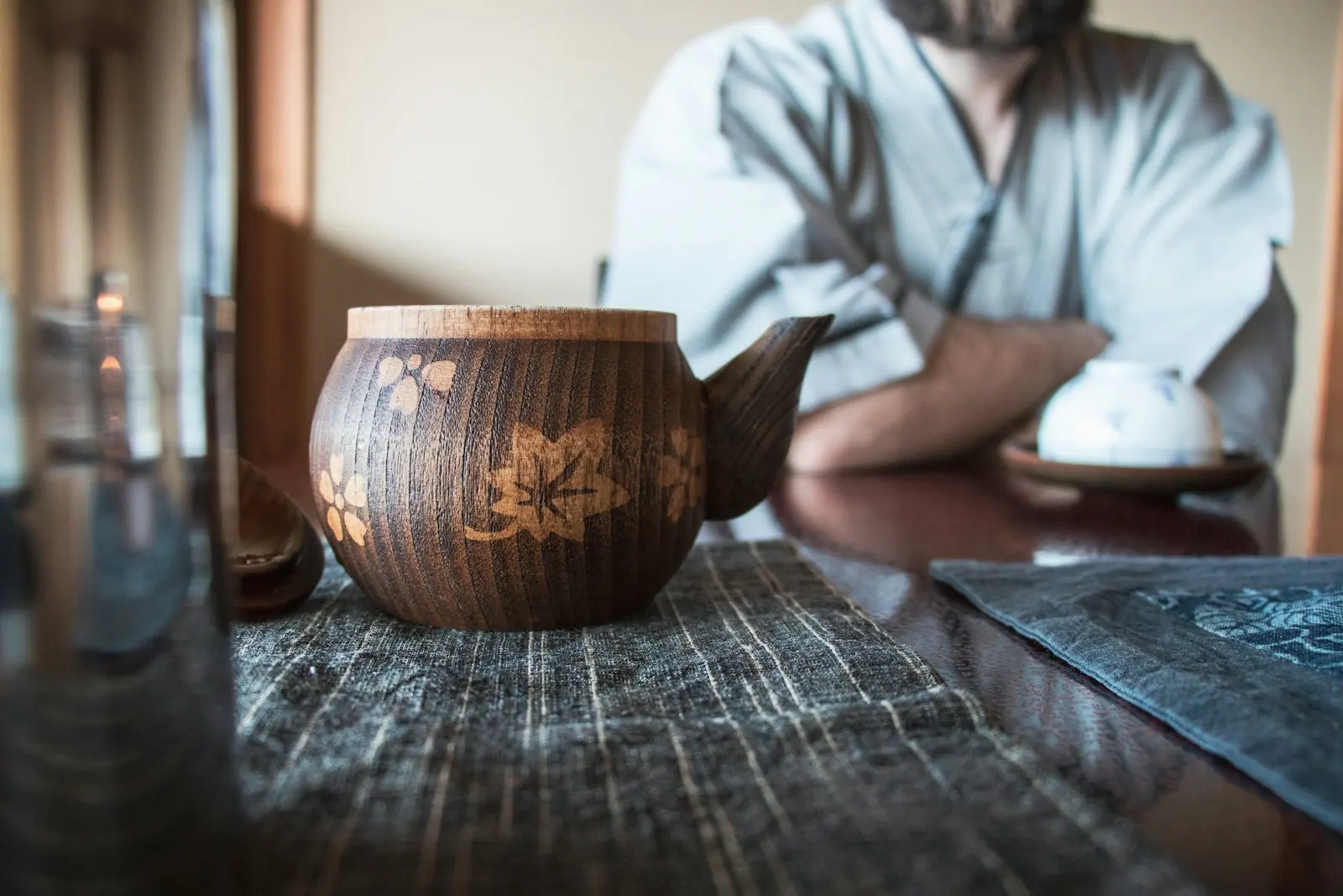 A pot of herbal tea steaming on a wooden tray