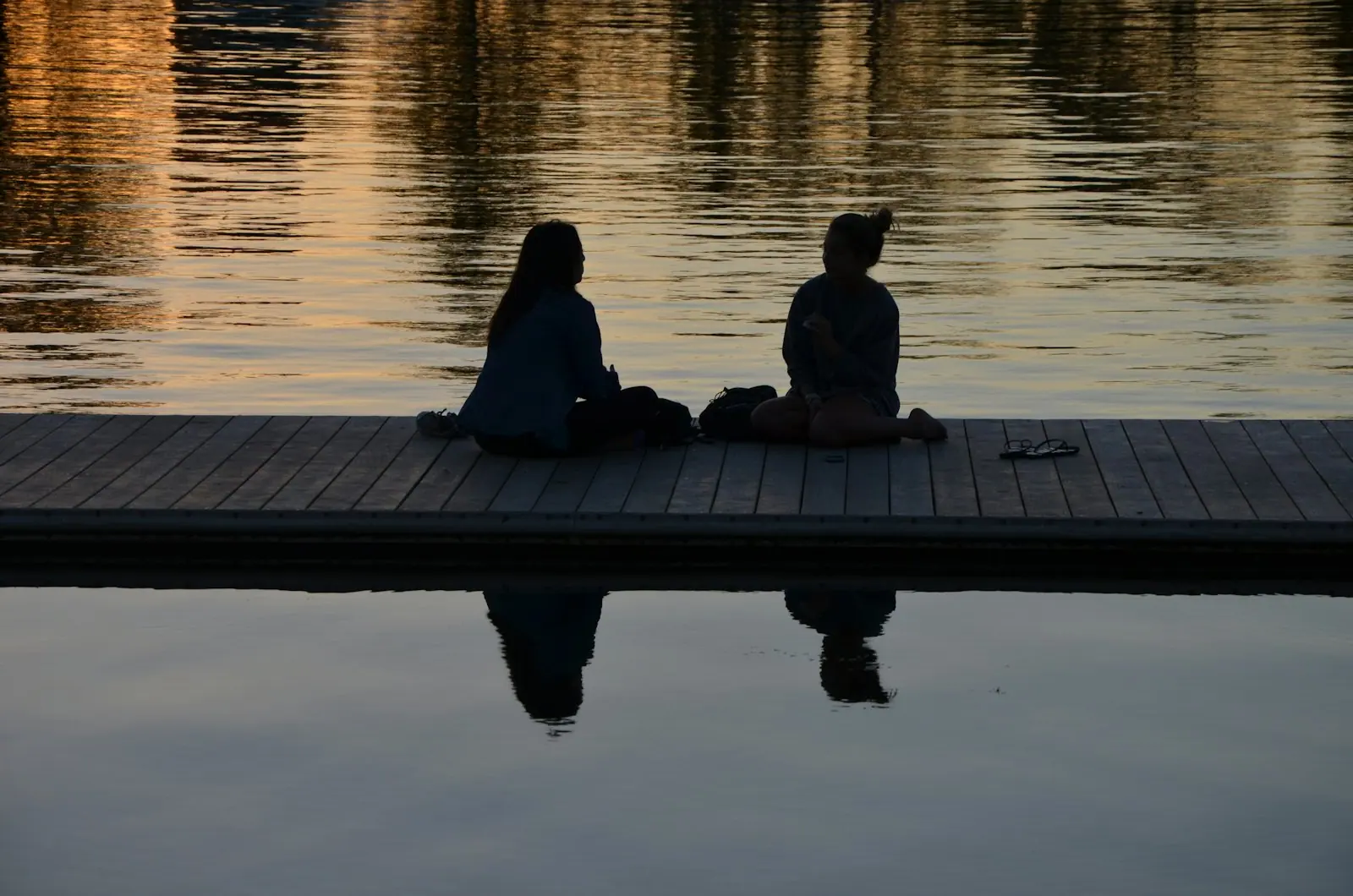 A sunrise meditation deck beside still water