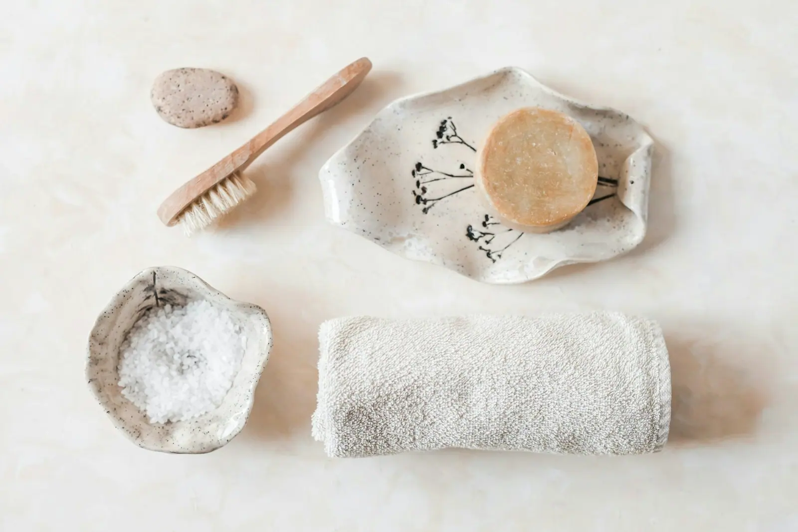 A still life of towel, flower and stone in a therapy room
