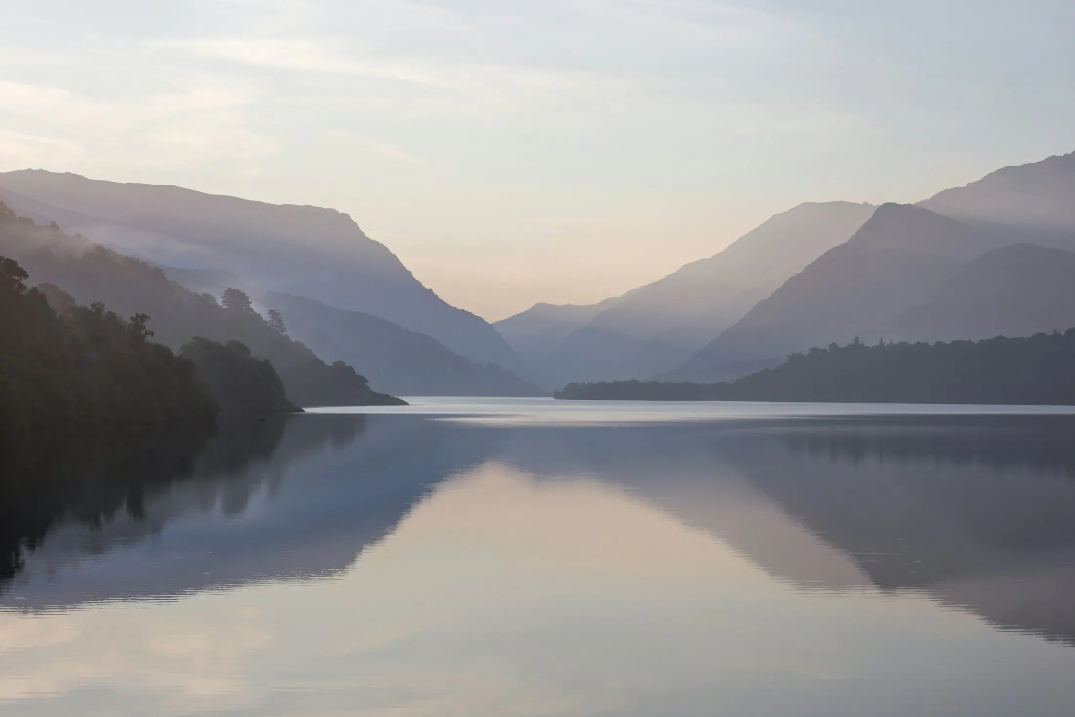 Morning mist rising from a still lake