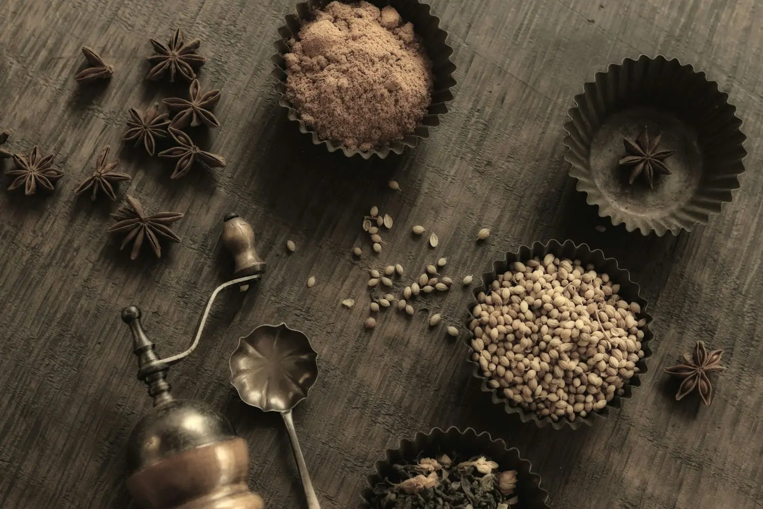 Spices in small bowls on a rustic surface