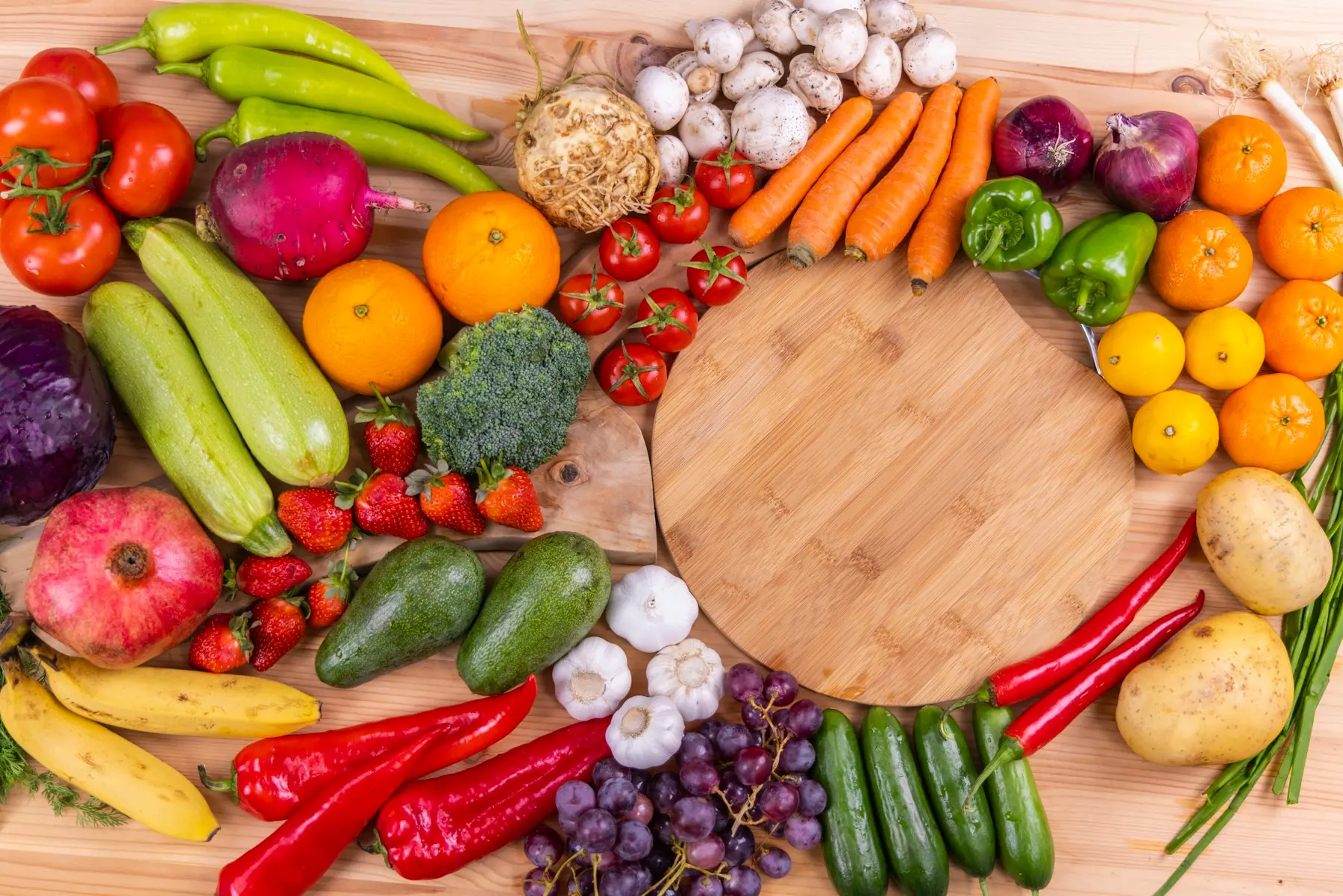 Fresh seasonal vegetables arranged on a wooden surface