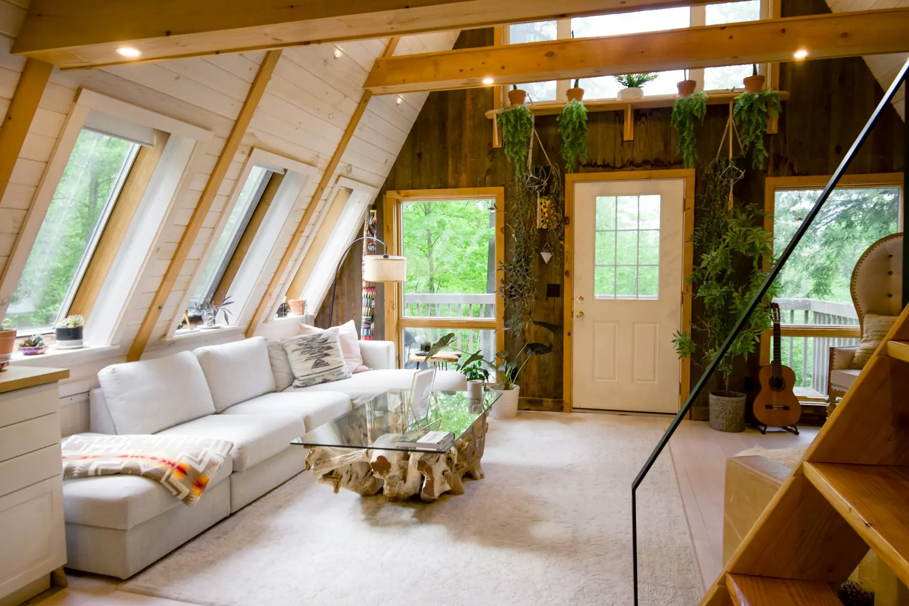 A suite with floor to ceiling windows looking into forest