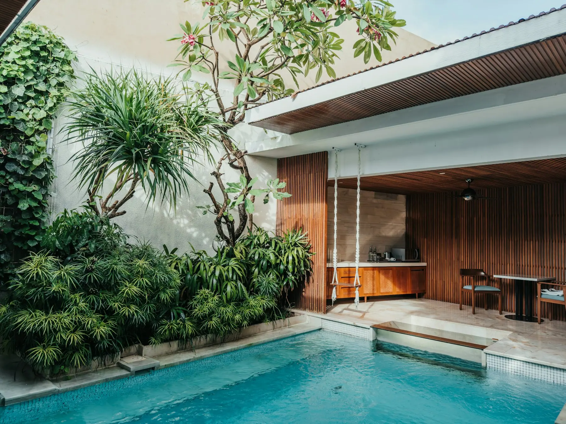 A private villa terrace with a plunge pool and greenery