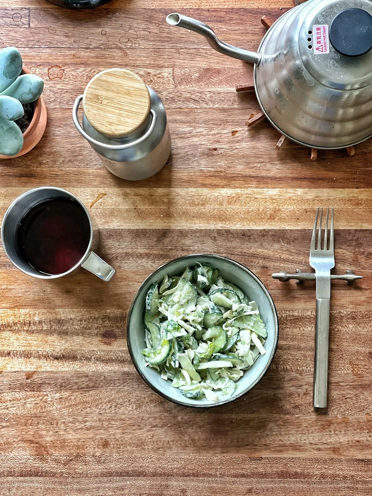 A simple bowl of food held at a wooden table